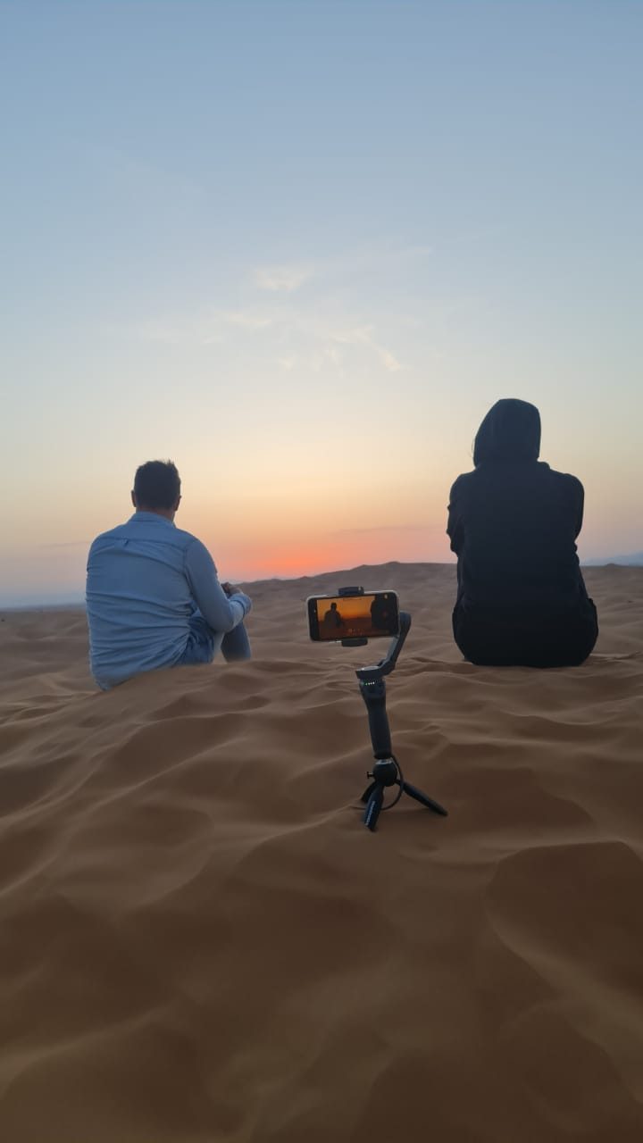 Sunrise over high red dunes during a dramatic desert sunrise