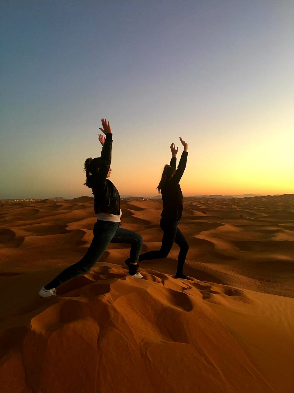 Sunrise quad bike ride on Dubai’s red dunes with early-morning desert glow